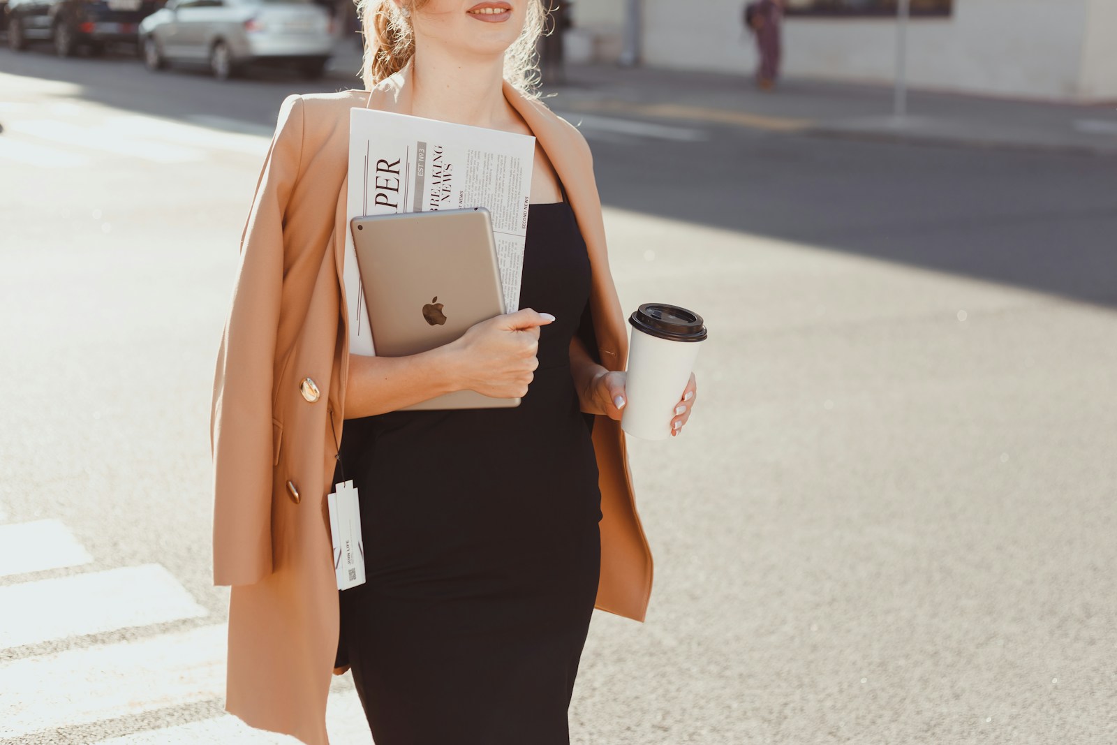 a woman in a black dress holding a cup of coffee